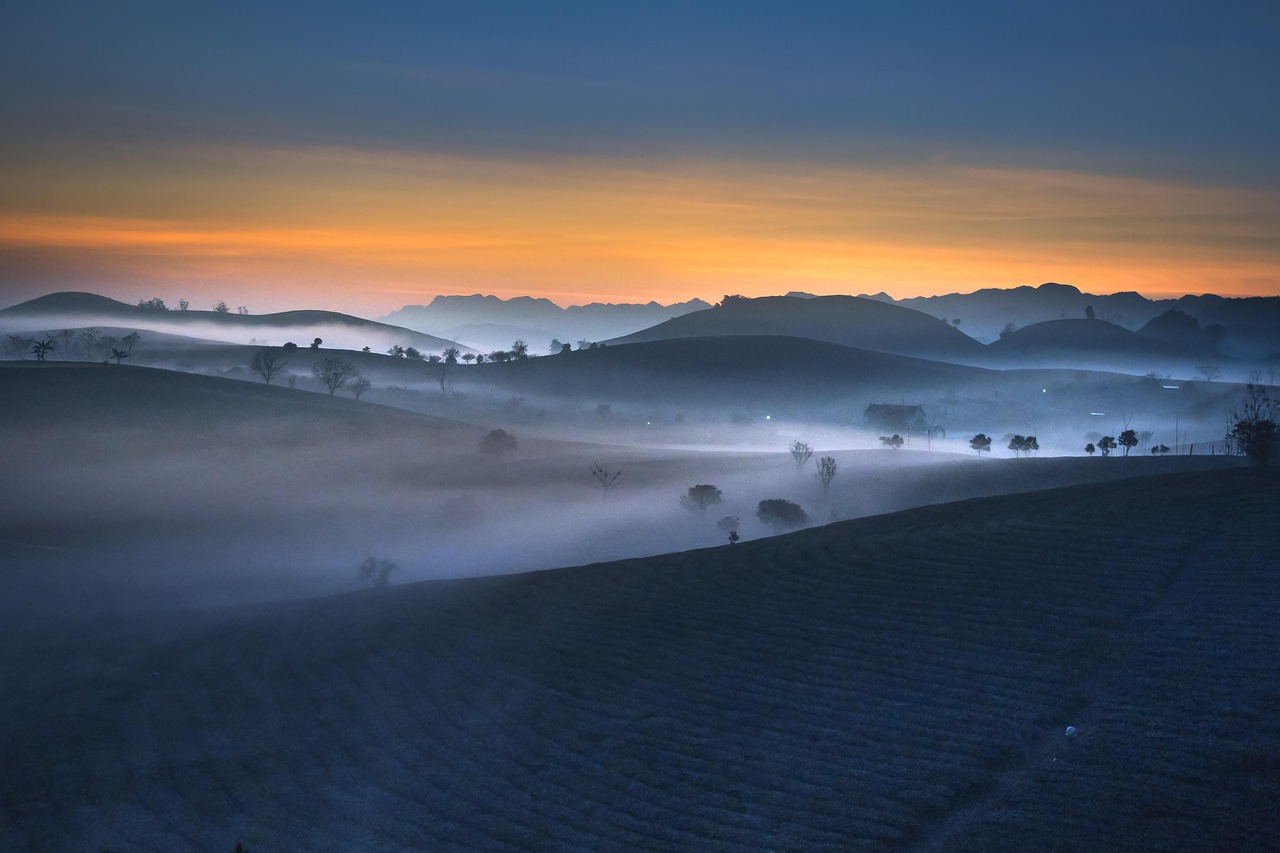 Panorama della valle all'alba, con luce dorata e nebbia leggera, prima dell'arrivo della folla.